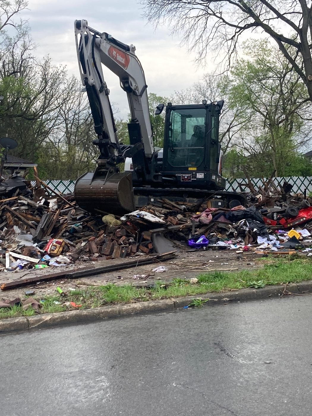 An excavator clears years of dumping
