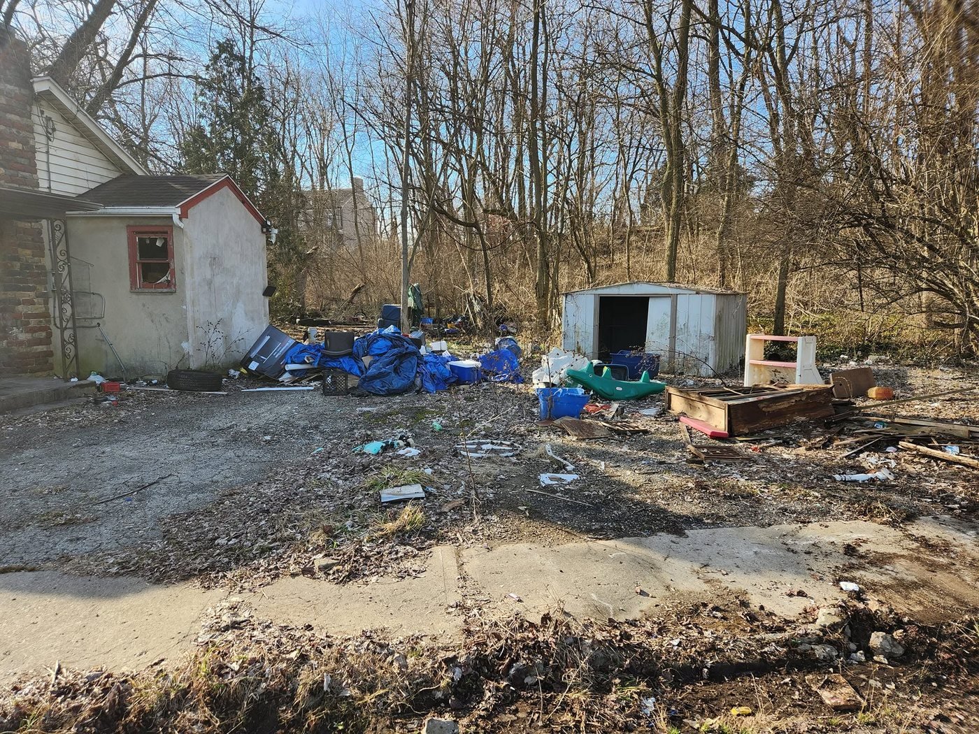 A vacant Dayton lot piled with illegally dumped trash before a clean-up